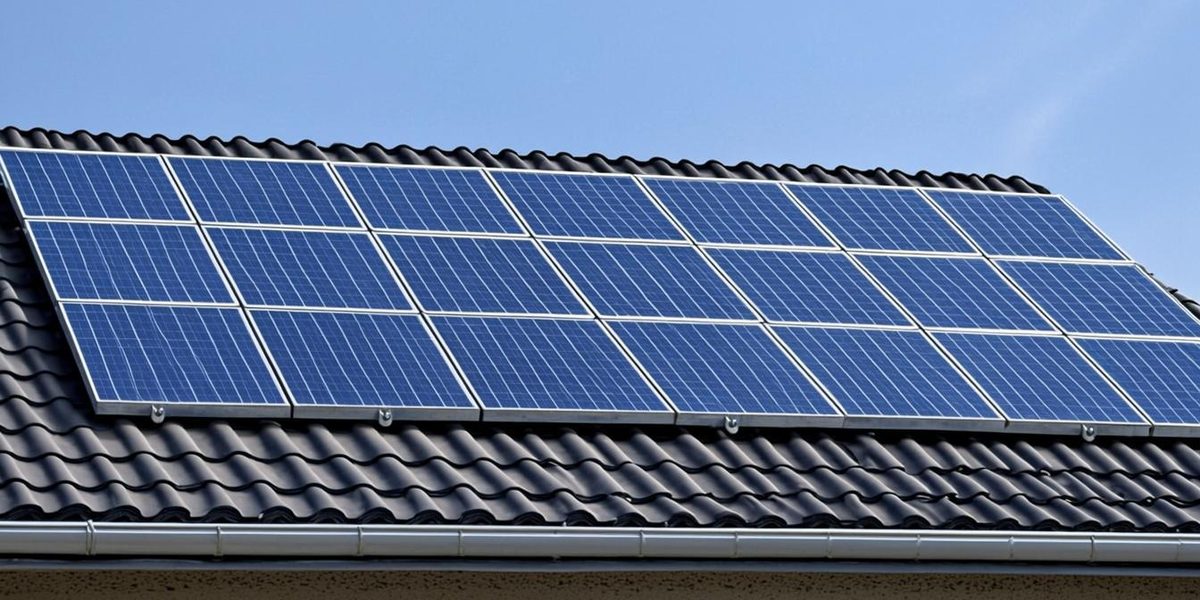 Dark solar panels in neat parallel rows mounted on uniform rails